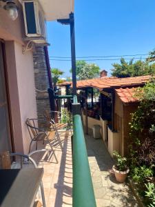 a green pole on a patio with a table and chairs at Hotel Alkionis in Ierissos