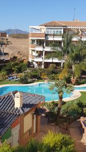 a resort with a swimming pool and a building at Green hills in La Cala de Mijas