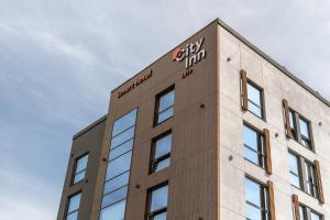 a building with a sign on the top of it at City Inn Lviv Smart Hotel in Lviv