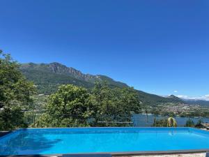 a swimming pool with a view of a mountain at Lake Apartment Ischia Red, Lago di Caldonazzo in Tenna 