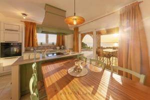 a kitchen with a wooden table and a dining room at Vista Villas - Sunny Pleasure Apartment Villa W in Ražanac