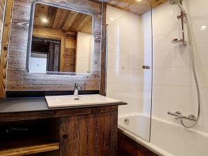 a bathroom with a sink and a shower and a mirror at Appartement Les Menuires, 2 pièces, 5 personnes - FR-1-344-595 in Les Menuires