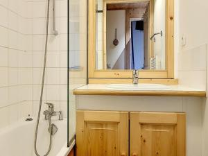a bathroom with a sink and a mirror and a tub at Appartement Les Menuires, 4 pièces, 10 personnes - FR-1-344-366 in Les Menuires