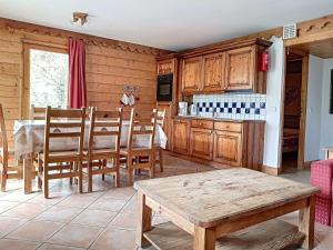 a kitchen with a table and wooden cabinets and a table sidx sidx at Appartement Les Menuires, 4 pièces, 6 personnes - FR-1-344-453 in Les Menuires