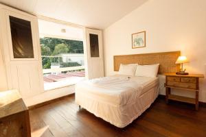 Een bed of bedden in een kamer bij Rede Reserva Bromélias