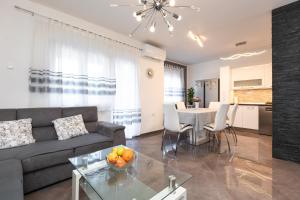 a living room with a couch and a table at Villa Nina Baška in Baška