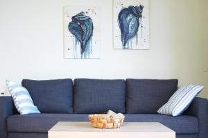 a blue couch with a table in a living room at Thalassa in Agios Nikolaos