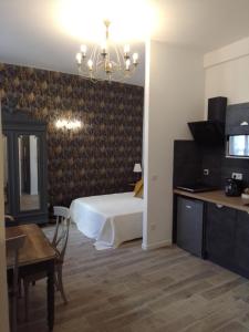 a bedroom with a bed and a desk and a table at LE GEORGE SAND Elégant studio coeur historique in Bourges