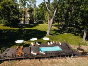 - une vue sur la piscine bordée de chaises et de parasols dans l'établissement Dwór Sieraków, à Sieraków