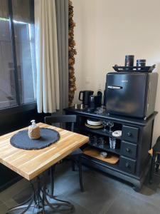 a kitchen with a table and a tv on a table at OSTAL 158 in Le Barp