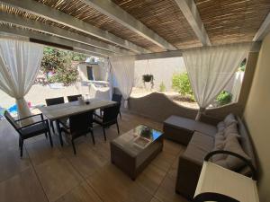 a living room with a couch and a table at Casa Teresa in Porto Pino