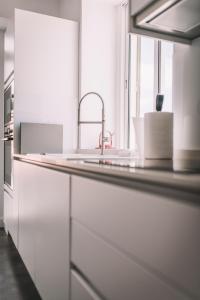 a kitchen counter with a sink and a window at QUINTA TORRINHA LUXODREAM Apartment in Funchal