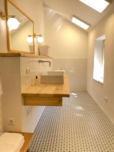 ein Bad mit einem Waschbecken und einem Spiegel in der Unterkunft Renaissancehof Wieser Wachau in Wösendorf