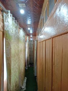 a corridor with wooden walls and curtains in a room at Houseboat New Jahangir And Morning Car in Srinagar