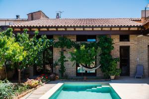 a house with a swimming pool in front of it at Ca l'Apotecari in Calaceite
