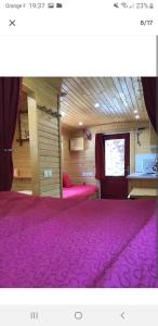 a room with a purple carpeted floor and a window at La roulotte au cœur de la côte d'opale in Marquise