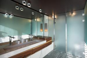 a bathroom with two sinks and a large mirror at Seven Apartments in Ascona