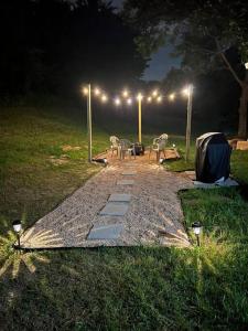 a table and chairs on a path at night at Experience Raleigh NC 8 minutes from the heart in Raleigh