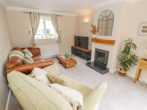 a living room with a couch and a fireplace at The Cornerstone in Cheltenham