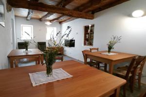 a dining room with two wooden tables and chairs at Agriturismo Casa Marietta in Tremea