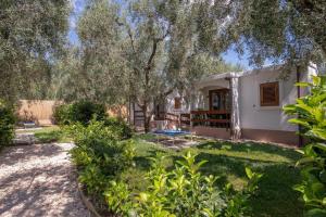 A garden outside Holiday Apartment orchidea with swimming pool and private beach -3