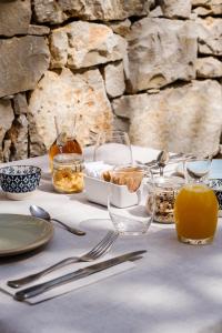 a table with glasses and bowls of food on it at Crocevia - Locanda carsica contemporanea in Trieste