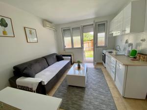 a living room with a couch and a kitchen at Central DELUXE Apartment in Prilep