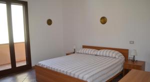 Кровать или кровати в номере Appartamenti famiglia Pinna - Villa Serena -