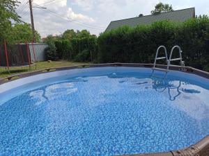 a large pool with blue water in a yard at U Ganca in Krajno Pierwsze