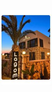 a building with a palm tree in front of it at LAGOM HOTEL in Seferihisar