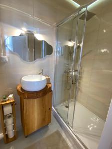 a bathroom with a sink and a shower at La Strada Apartments in Oradea +12 photos