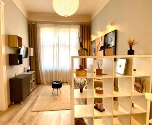 a living room with a book shelf with potted plants at La Strada Apartments in Oradea