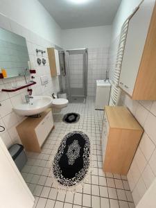 a bathroom with a sink and a toilet and a mirror at Gästewohnung in Halle an der Saale