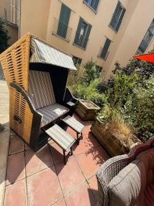 a patio with a chair and a bench and a building at Gästewohnung in Halle an der Saale