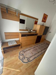 a bathroom with a sink and a mirror and a rug at Gästewohnung in Halle an der Saale