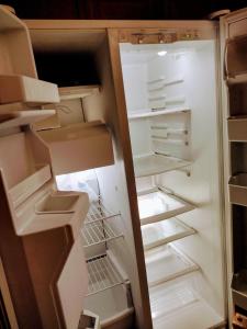 an empty refrigerator with its door open with its door open at Beautiful large bedroom in Orlando