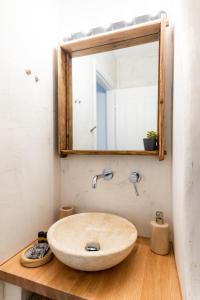 a bathroom with a sink and a mirror at Anna's Apartments in Mikonos