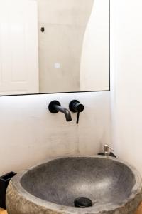 a sink in a bathroom with a mirror at Anna's Apartments in Mikonos