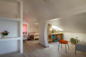 a living room with a table and a chair and a bedroom at Apartmani Smokovo in Jadranovo