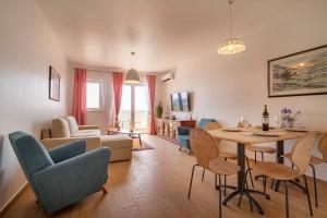 a living room with a table and chairs at Apartmani Smokovo in Jadranovo