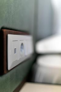 a close up of a light switch on a wall at Hotel Ponta Delgada in Ponta Delgada