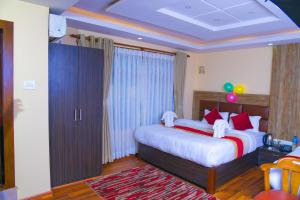 Rúm í herbergi á Hotel Airport Deepshree