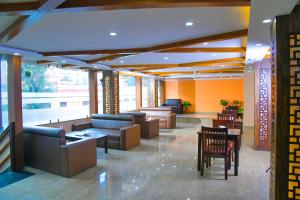 a lobby with couches and tables in a building at Hotel Airport Deepshree in Kathmandu