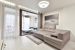 a living room with a couch and a table at Apartmentai "Nidos Vilnelė" in Nida