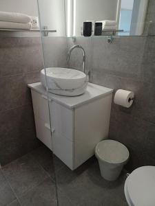 a bathroom with a sink and a toilet at Mediteran Hvar - Modern Rooms and Restaurant, B&B in Vrboska