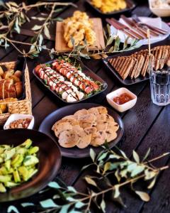 a table topped with plates of food and snacks at Mediteran Hvar - Modern Rooms and Restaurant, B&B in Vrboska