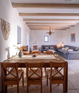 a living room with a wooden table and chairs at Antiparos Luxury Villas in Andiparos