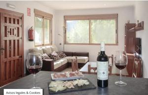 a living room with two glasses of wine on a table at Apartamento Sierra Espuña in Alhama de Murcia