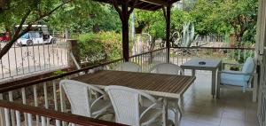 a wooden table and chairs on a patio at A&B Home Hotel in Göcek