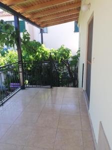 a balcony with a black gate and a tile floor at North Evia Evanthia Greece in Kourkouloí